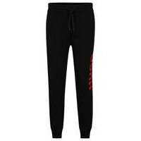 Cuffed tracksuit bottoms in French terry with contrast logo, Hugo boss