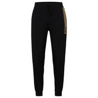 Cotton-terry tracksuit bottoms with logo and stripe, Hugo boss