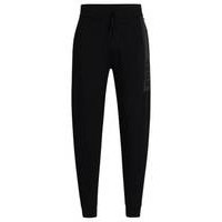 Cuffed tracksuit bottoms in French terry with logo print, Hugo boss
